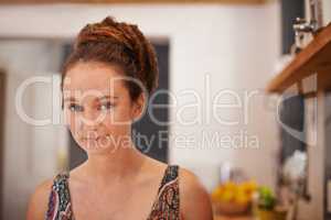 Shes got alternative style. Portrait of a young woman with dreadlocks standing in her home.