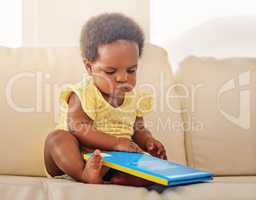 Fine, Ill read it myself. Full length shot of a baby girl sitting on the sofa at home.