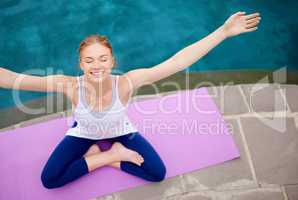 Yoga is a way to freedom. Shot of a young woman doing yoga outdoors.