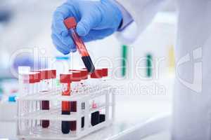 Lets hope Dracula is not around. Cropped shot of a scientist holding a test tube filled with blood.