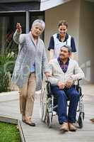 Look at all the facilities they have here. Shot of a senior woman showing her husband around a retirement home with a nurse.