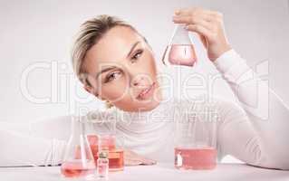 She is wine of love. Studio shot of young woman making a potion against a white background.