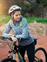 All she needs is her bike and a trail. Shot of a female mountain biker out for an early morning ride.