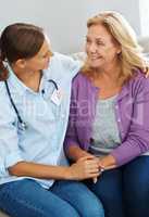 She enjoys every visit. Shot of a young nurse talking to her senior patient.
