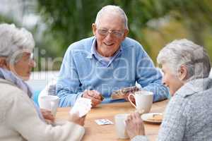 I can beat these two. A group of senior citizens playing cards together.