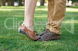 Closeup on young love. Cropped shot of a young girl standing tiptoe on her boyfriends feet.