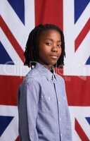 National pride. Portrait of a proud young boy standing in front of the Union Jack.
