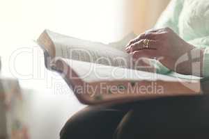 Faith comes first. Closeup shot of an unrecognisable woman reading a bible.