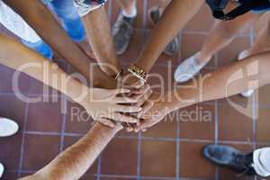 United. Cropped view of a multiethnic group putting their hands together in unity.