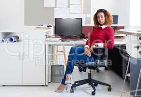 Shes always the last one in the ofifce. Portrait of a young designer sitting at her workstation in an office.