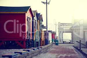 Morning mist on the waterfront. Shot of a wendy houses on a waterfront walkway in the morning.