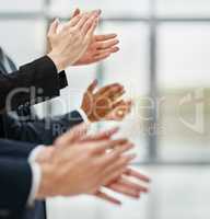 Outstanding presentation. Closeup shot of a group of executives clapping while standing in a row in an office.