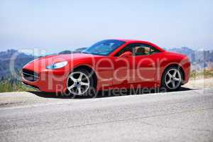 Red cars go faster. Shot of a young woman driving in a sports car.