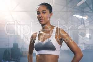 This is a what a champion looks like. Portrait of a focused young sportswoman posing in the gym.