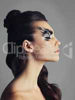 Rethink makeup as a tool for creativity. Studio shot of an attractive young woman wearing bold eye makeup.
