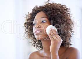 Pamper your skin. Shot of a beautiful young woman during her daily beauty routine.
