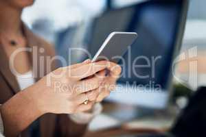 Building business with her extensive network. Closeup shot of an unrecognizable businesswoman using her cellphone in an office.