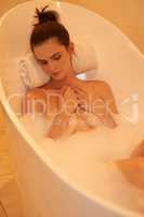 This is how you end a stressful day. High angle shot of an attractive young woman taking a bubble bath.