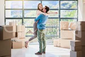 Theyre excited to be owning their dream home. Shot of a young couple celebrating their move into a new home.