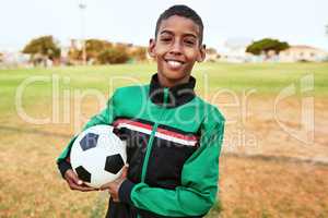 Its good to have goals. Portrait of a young boy playing soccer on a sports field.