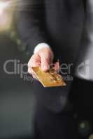 Commerce and consumerism. Shot of a businessman holding out a credit card.