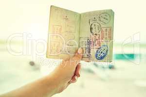 What I use to see the world. Shot of an unrecognizable person holding a passport indoors.