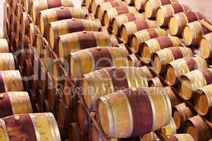 Waiting until the time is right. Red wine barrels stored in wine cellar.
