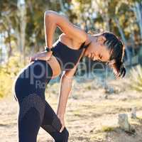 Sore muscles can really sabotage your workout. Shot of a young woman experiencing back pain while working out in nature.