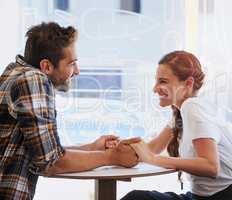 Spending Saturday their favorite way. Shot of a happy young couple spending time together in a coffee shop.