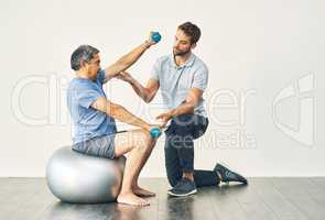 Keep your form. Full length shot of a young male physiotherapist assisting a senior patient in recovery.