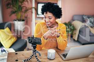 I cant wait to hear from you guys. Cropped shot of a woman recording a video for her blog at home.