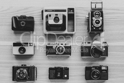 Vintage photo cameras on wooden background.