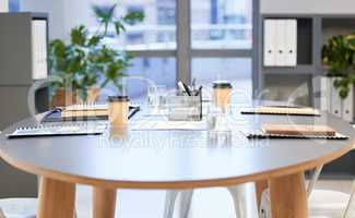 Looks like the meetings been adjourned. Shot of a well-lit modern office boardroom with nobody in it.