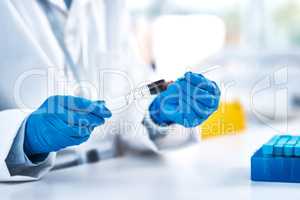 You have to work with extreme caution in the lab. Closeup shot of an unrecognisable scientist using a syringe while working in a lab.