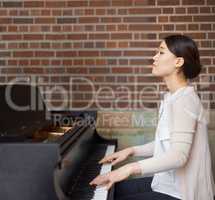 Playing from the heart. Cropped shot of pianist playing the piano.