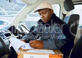 Lets get the day started. Shot of young man delivering a package while sitting in a vehicle.