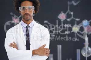 Hes always had an analytical mind. A male scientist standing in front of a blackboard filled with drawings of chemical bonds.