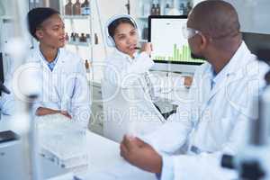 Combined skills for comprehensive scientific studies. Shot of a group of scientists conducting research in a laboratory.