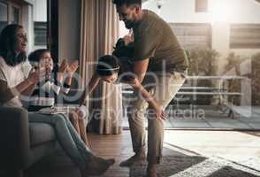 Theres always time for family. Shot of a happy young family spending quality time together at at home.