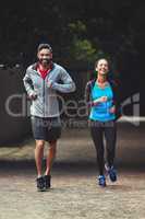 Ditch the gym and exercise outside. Shot of a couple out running together.