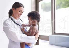 Just in for a routine pediatric checkup. Cropped shot of a female pediatrician doing a checkup on an adorable baby boy.