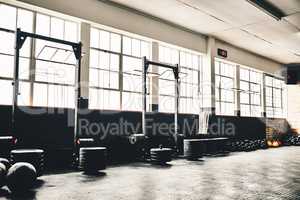 They are ready to get tested on. Shot of the interior of a health club full of gym equipment ready for use.