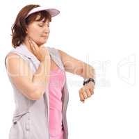 Making sure her heartbeat feels healthy. Mature woman taking her pulse rate against a white background.