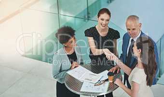 Forming partnerships to strengthen business. Cropped shot of a group of businesspeople shaking hands during a meeting in an office.