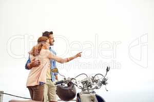 Enjoying the sights while out on a road trip. Shot of an adventurous couple out for a ride on a motorbike.