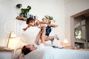 This is what sweet dreams are made of. Shot of a man and his son being playful before bedtime.