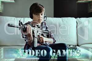 Lock and load time. Shot of a young boy playing violent video games.