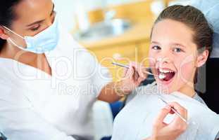 No worries for this checkup. Portrait of a young girl have a checkup at the dentist.