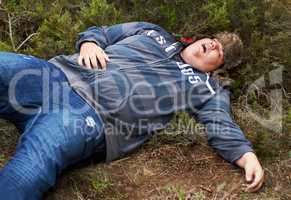 Suffering the consequences of a wild night.... An obese young man lying passed-out outside in the bushes.