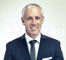 Youre never fully dressed without a smile. A cropped portrait of a happy mature man wearing a pinstripe suit.